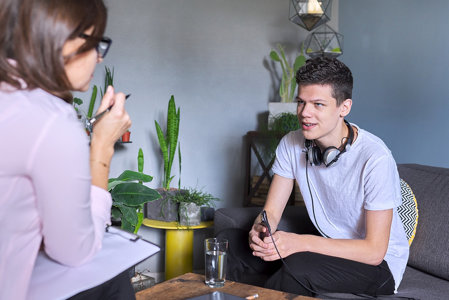 therapist speaking with young man